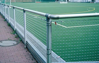 Square cable mesh around a football stadium to protect surrounding spectators.